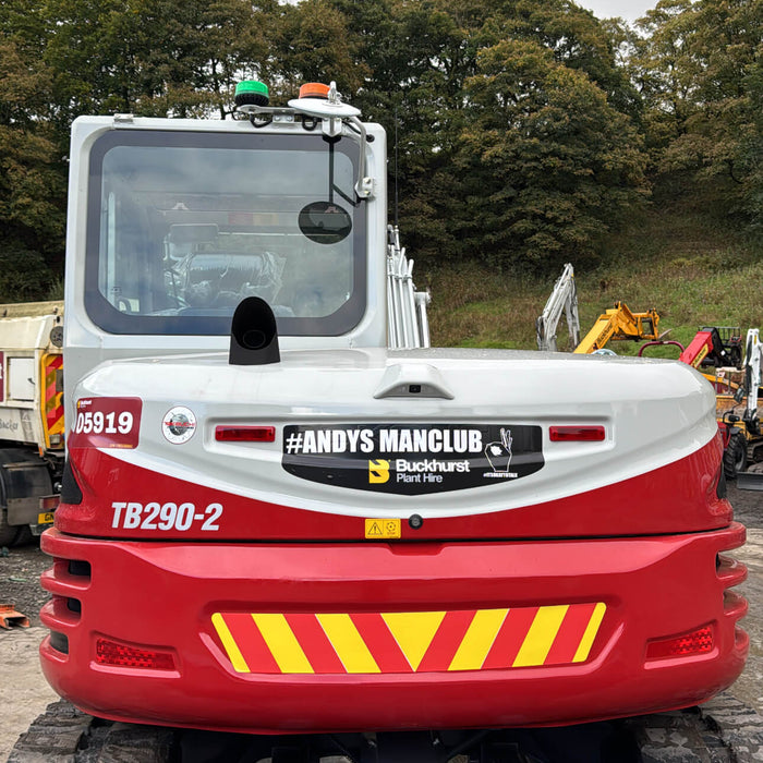 A red and white Takeuchi excavator, stickered with Andys Man Club branding.