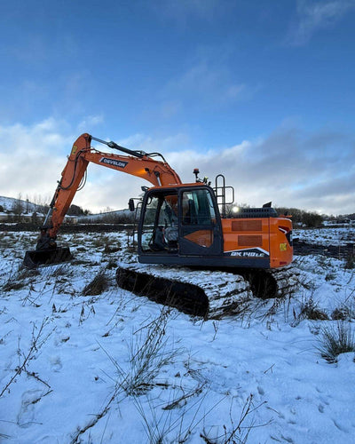 Develon-Wide-Tracked-Excavator-In-The-Snow. 