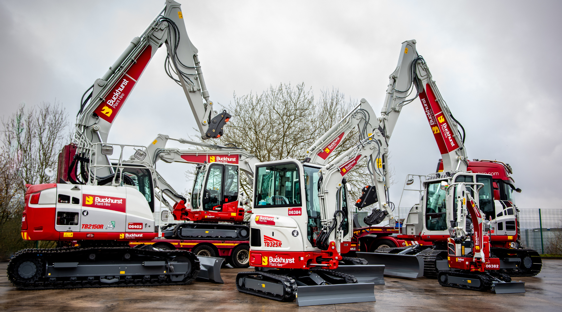 Six red and white Takeuchi excavators with Buckhurst Plant Hire branding.