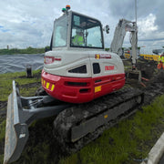 6 tonne excavator on a construction site with a cloudy sky in the background