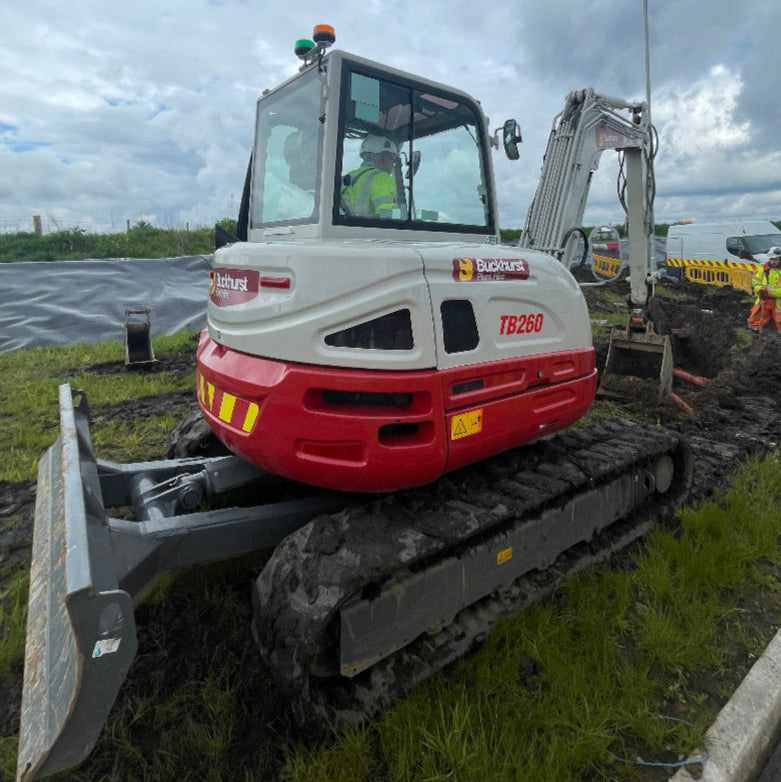 6 tonne excavator on a construction site with a cloudy sky in the background
